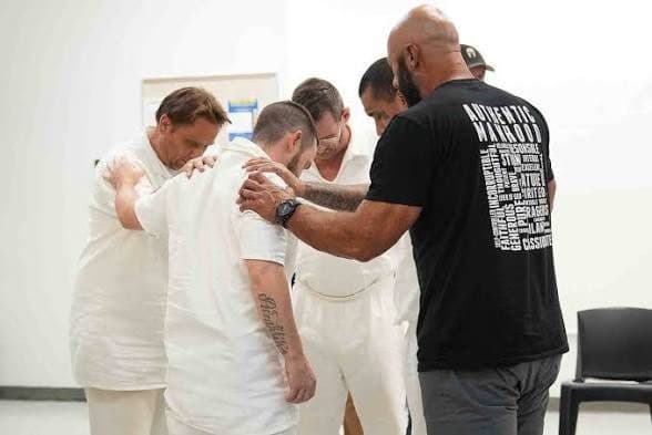 A circle of people praying together